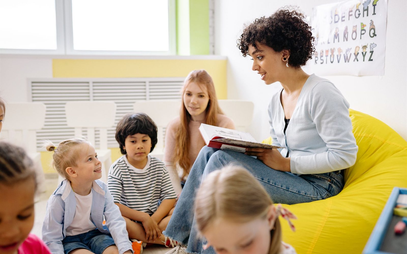 Teacher reading a story to a group of children