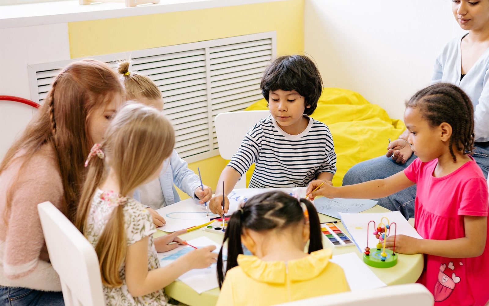 Children working together on an art project around a table
